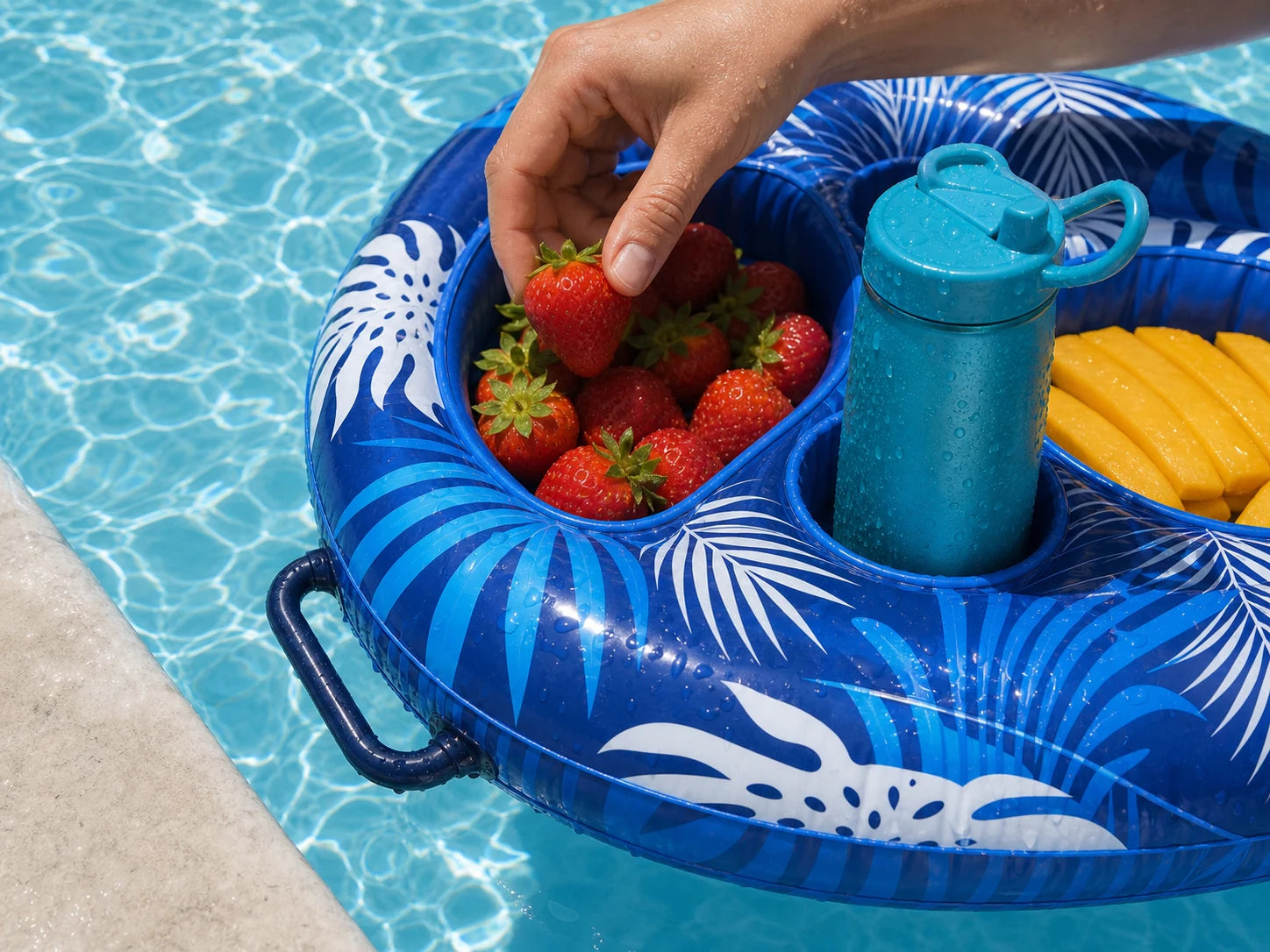 Close view of a hand reaching for fruit from the Poolora Float